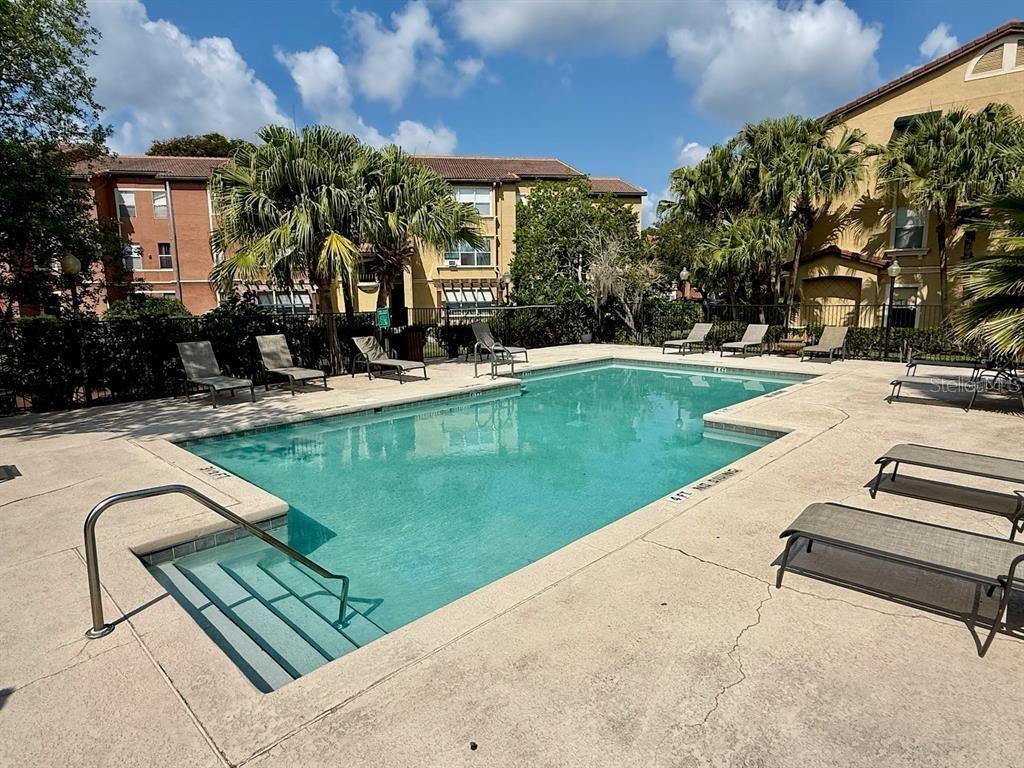 5120 Conroy Road, Unit 13 Orlando, FL 32811 - Photo 20 of 25 swimming pool view with a seating space and garden view