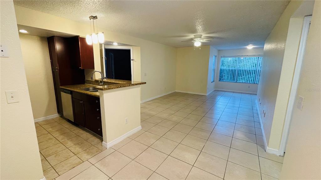 5120 Conroy Road, Unit 13 Orlando, FL 32811 - Photo 2 of 25 a view of a kitchen with a sink and a refrigerator
