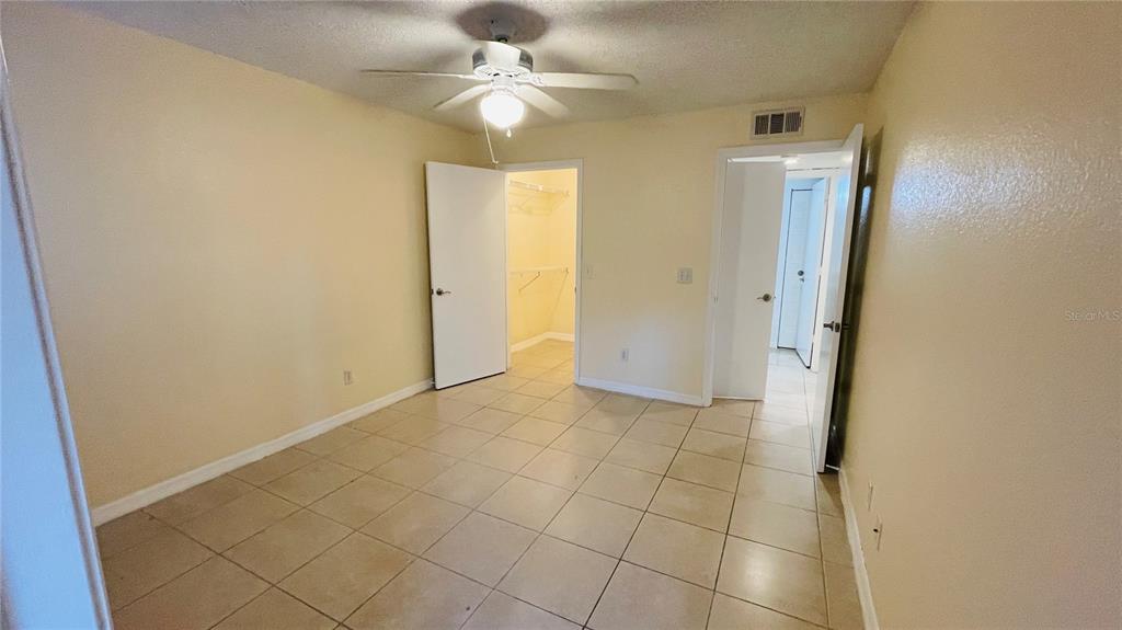 5120 Conroy Road, Unit 13 Orlando, FL 32811 - Photo 8 of 25 an empty room with fan and entrance