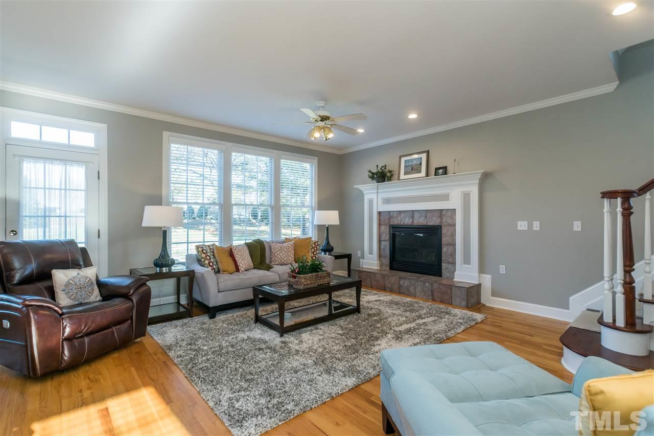 1000 Nortonbridge Road Raleigh, NC 27603 - Photo 11 of 30 a living room with furniture large window and a fireplace