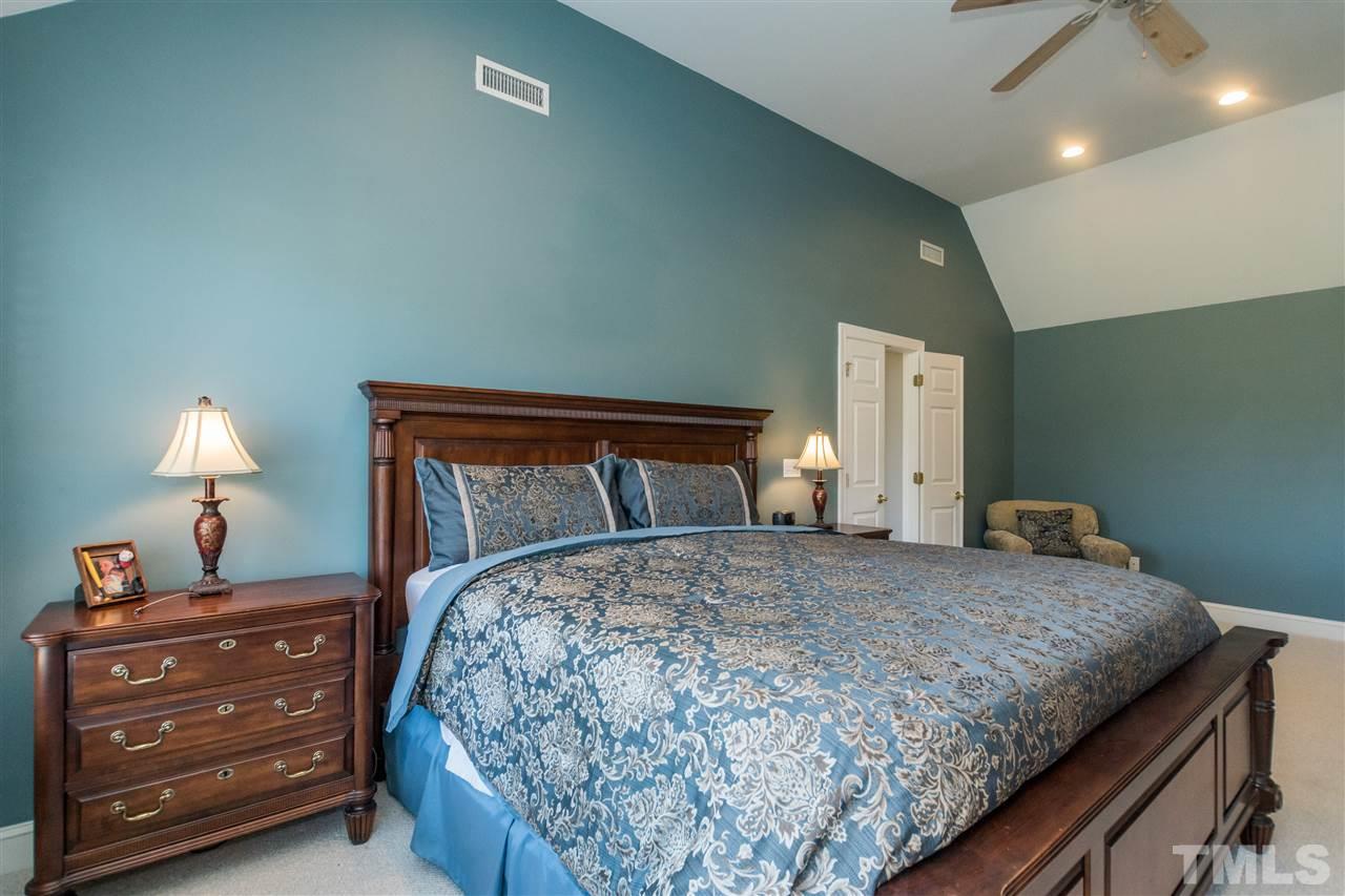 1000 Nortonbridge Road Raleigh, NC 27603 - Photo 15 of 30 a bedroom with a bed and a lamp on dresser