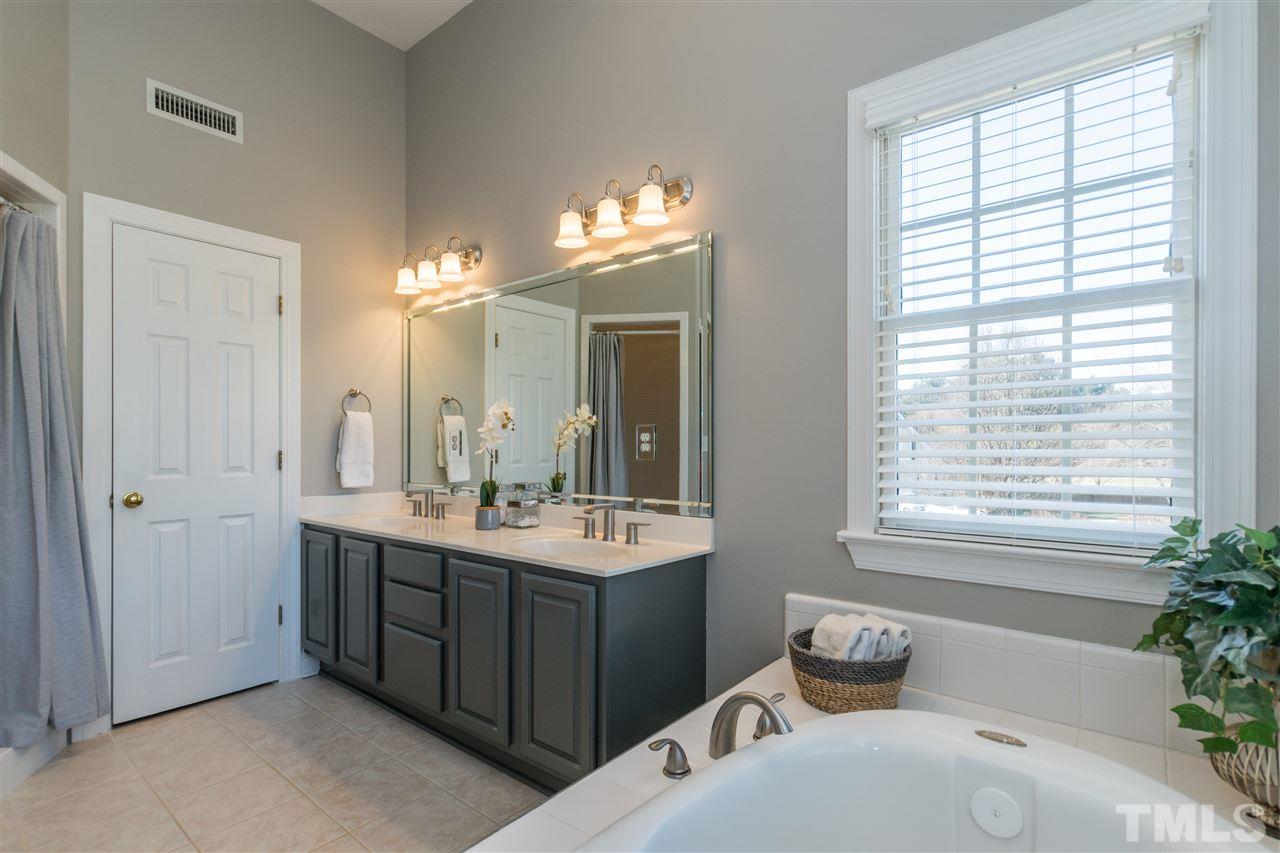 1000 Nortonbridge Road Raleigh, NC 27603 - Photo 19 of 30 a bathroom with a tub sink and mirror