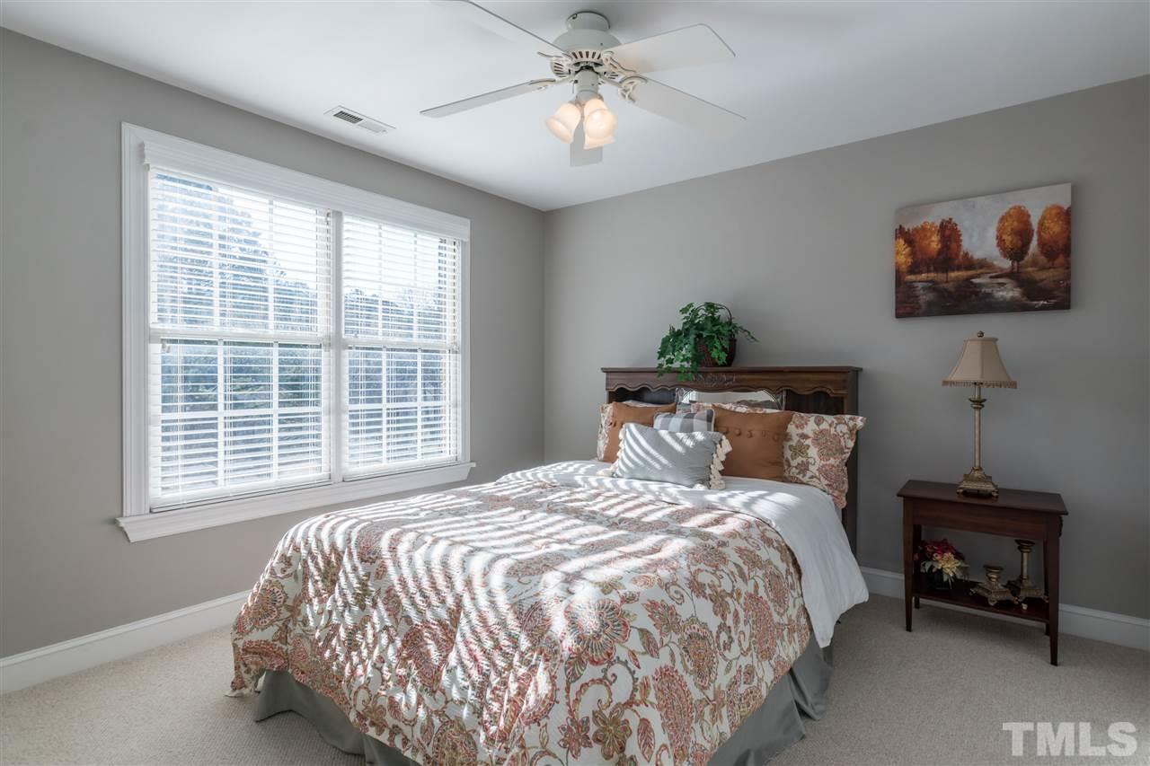 1000 Nortonbridge Road Raleigh, NC 27603 - Photo 20 of 30 a bedroom with a bed and a chandelier