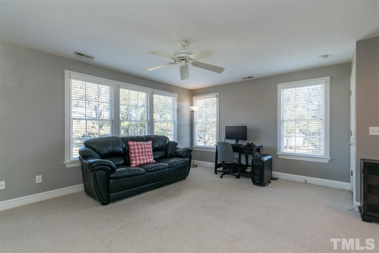 1000 Nortonbridge Road Raleigh, NC 27603 - Photo 24 of 30 a living room with furniture and a chandelier