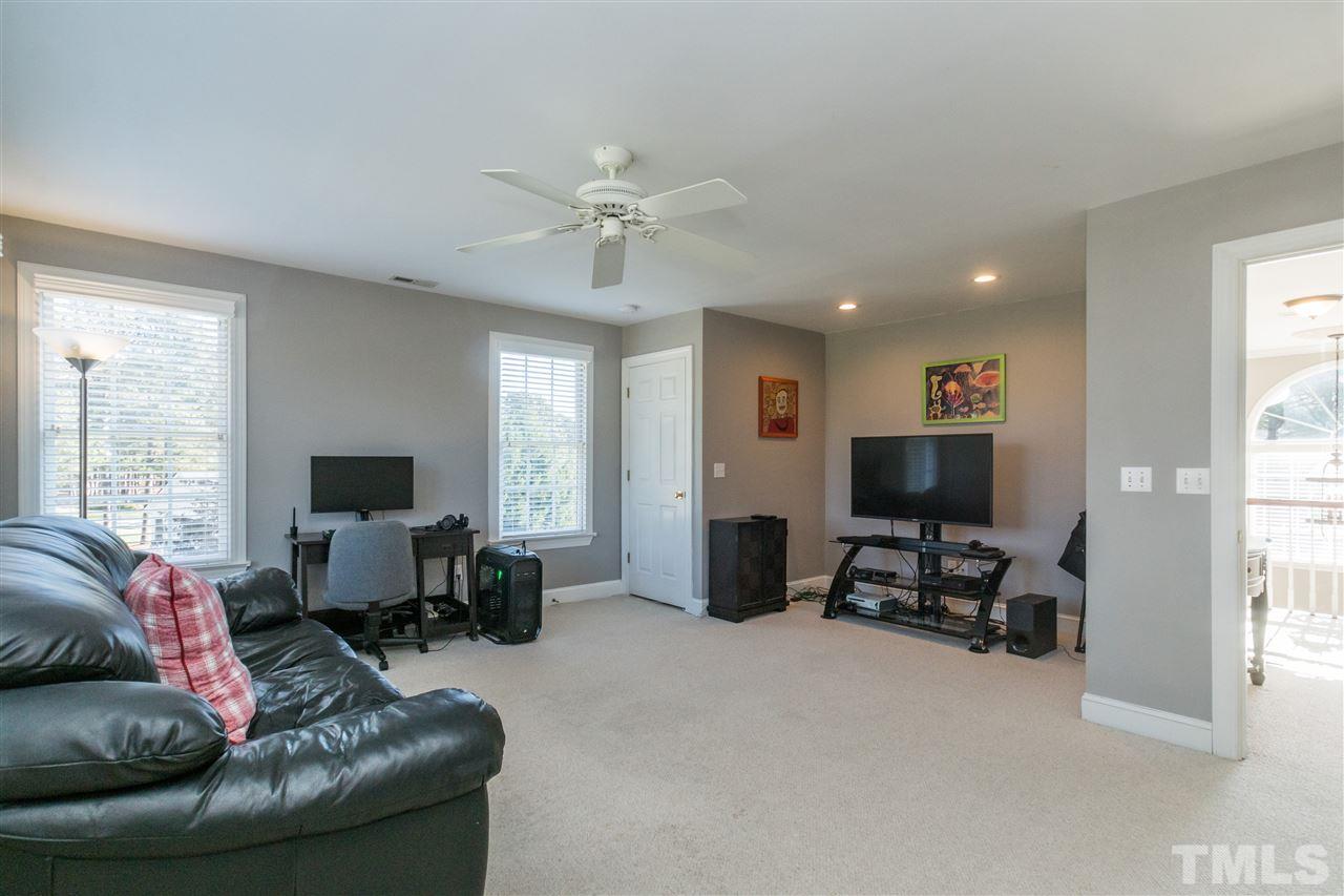 1000 Nortonbridge Road Raleigh, NC 27603 - Photo 25 of 30 a living room with furniture and a flat screen tv
