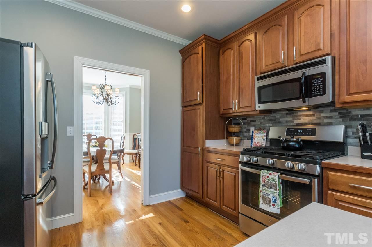 1000 Nortonbridge Road Raleigh, NC 27603 - Photo 4 of 30 a kitchen with stainless steel appliances granite countertop a stove top oven a sink dishwasher a refrigerator and cabinets with wooden floor