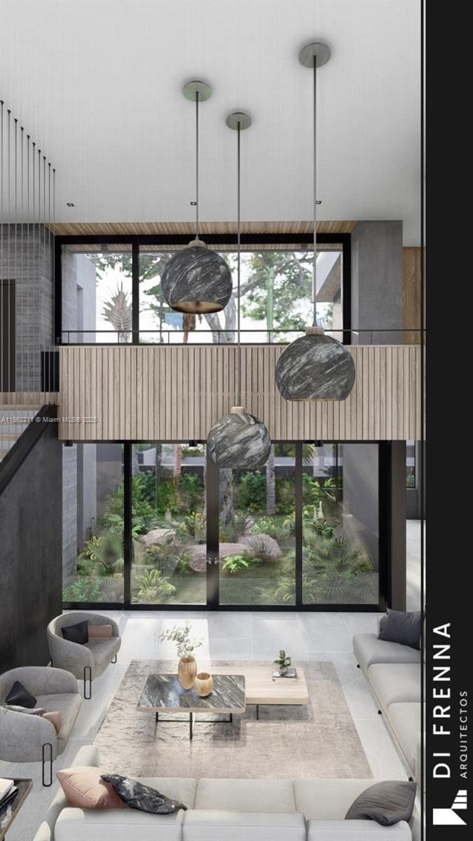 2664 Southwest 17th Avenue Miami, FL 33133 - Photo 13 of 56 a living room with a floor to ceiling window and stairs