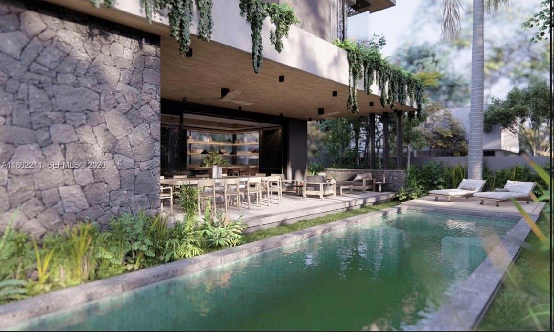 2664 Southwest 17th Avenue Miami, FL 33133 - Photo 17 of 32 a view of pool with lawn chairs and plants