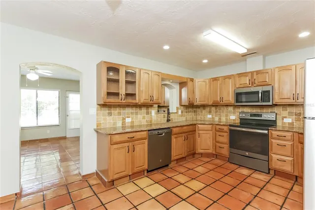 a kitchen with stainless steel appliances granite countertop a sink and cabinets