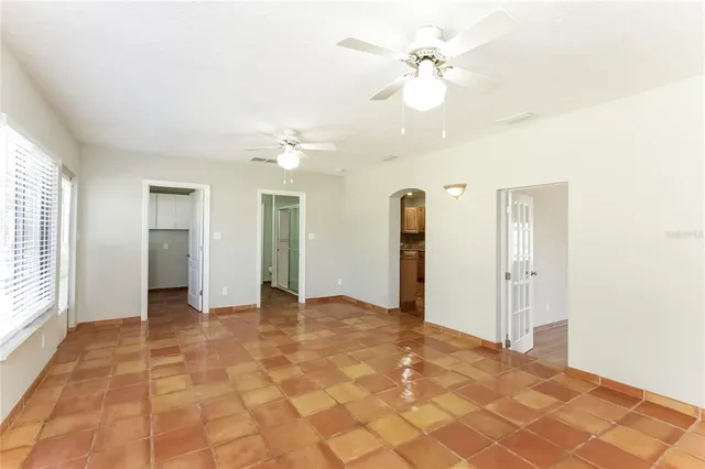 a view of a big room with closet and a chandelier fan