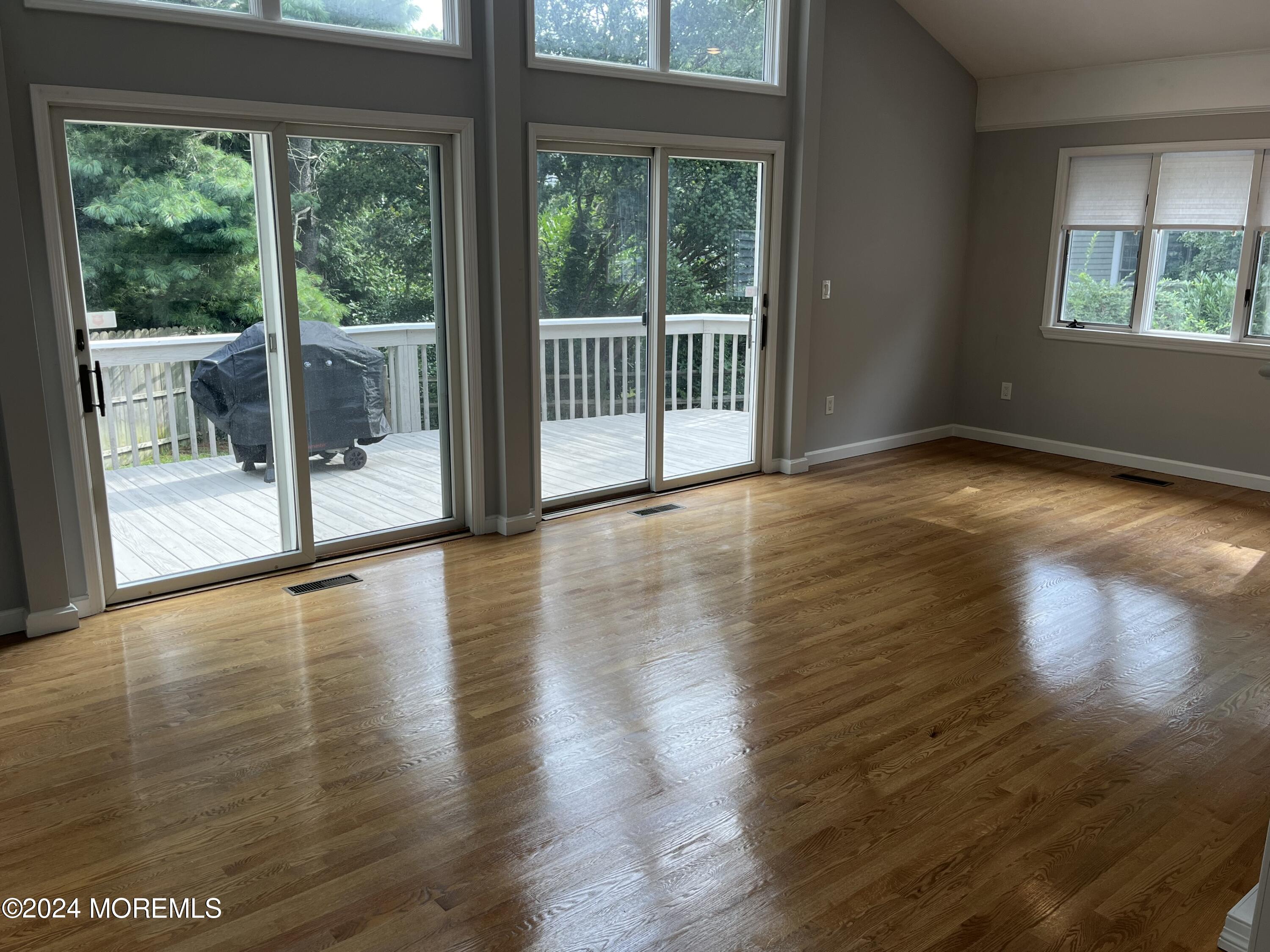 22 Robin Road Rumson, NJ 07760 - Photo 11 of 24 a view of a room with wooden floor and floor to ceiling window