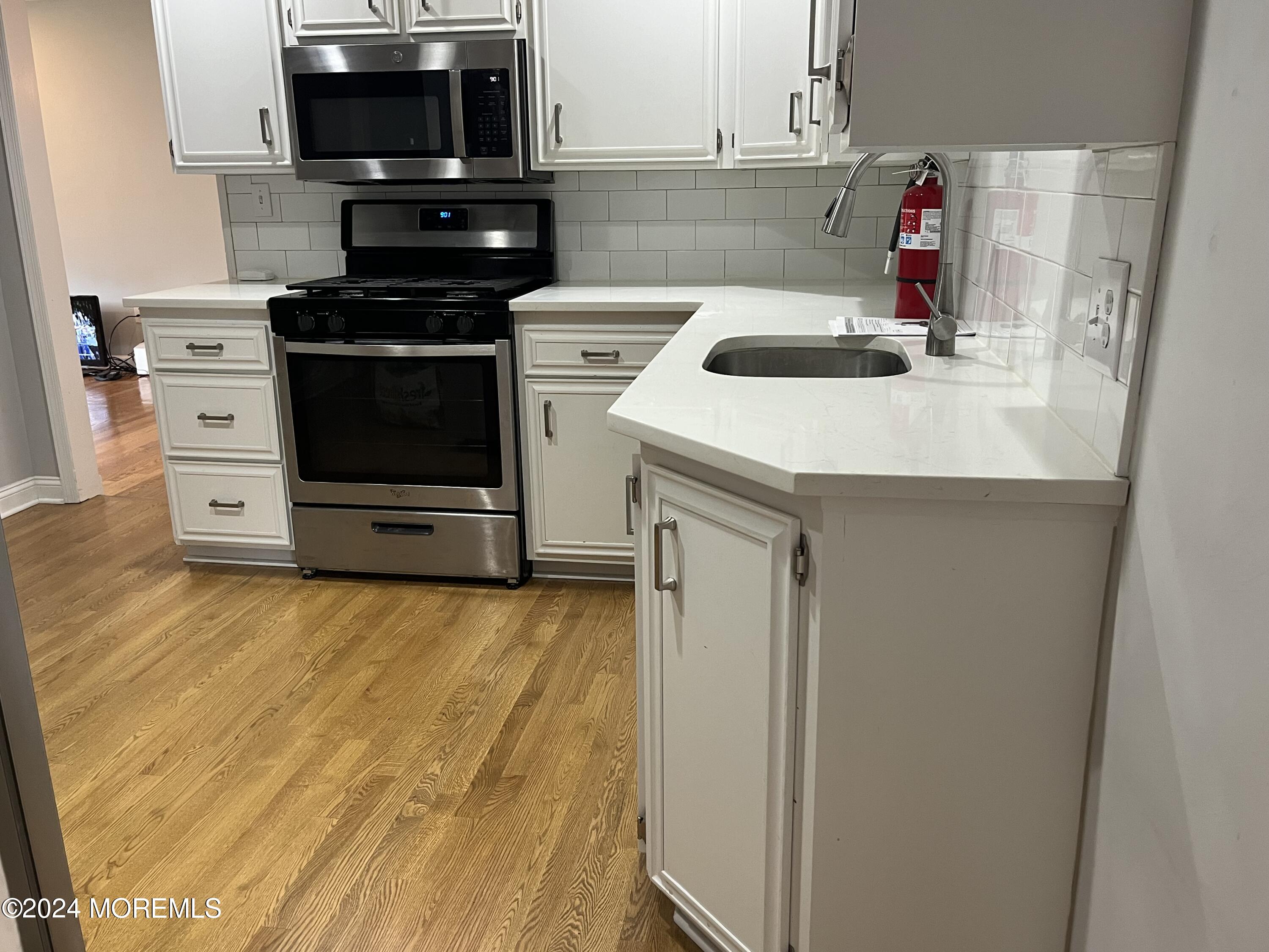 22 Robin Road Rumson, NJ 07760 - Photo 12 of 24 a kitchen with a sink and steel appliances