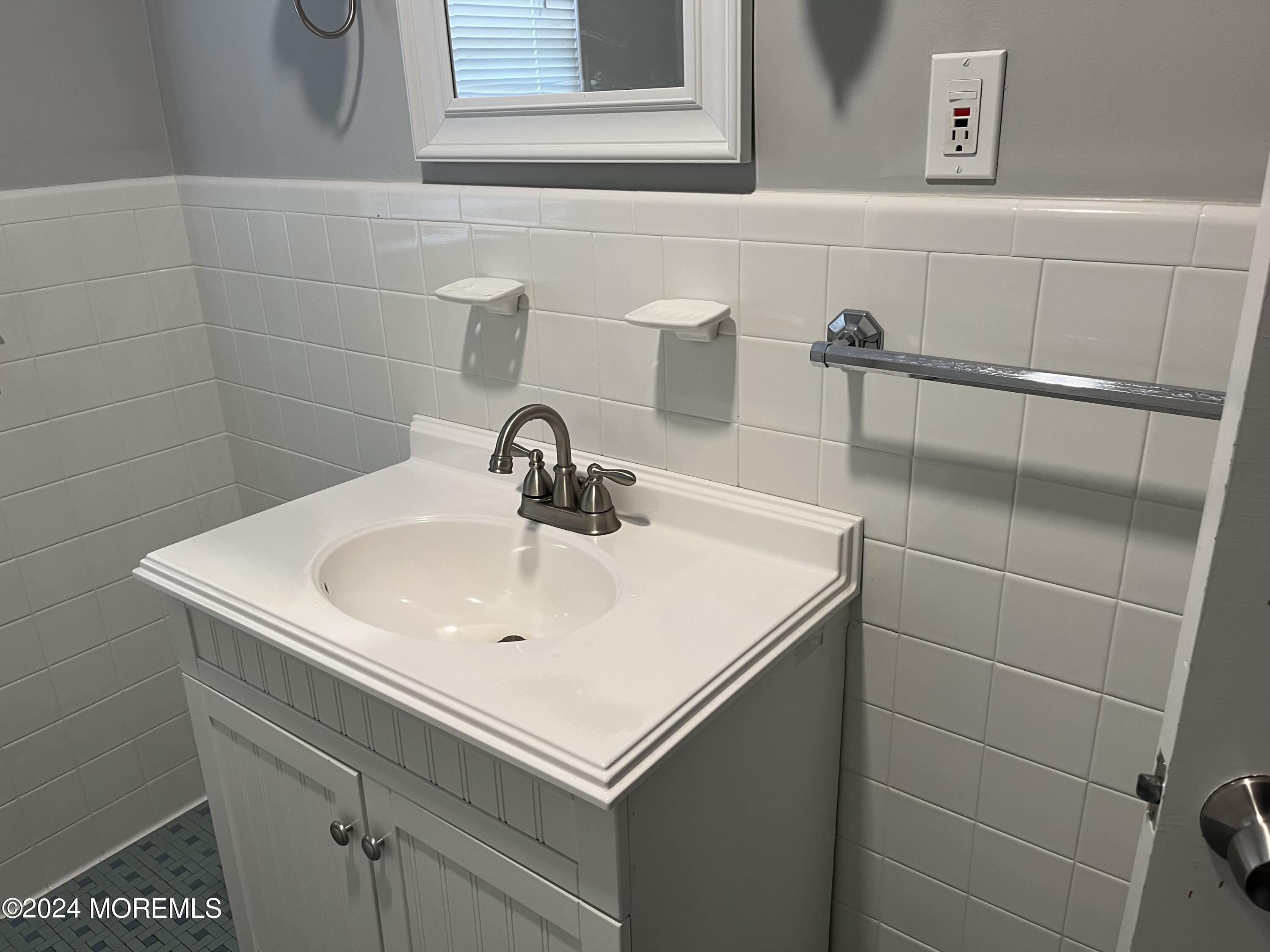 22 Robin Road Rumson, NJ 07760 - Photo 14 of 24 a bathroom with a sink and a vanity