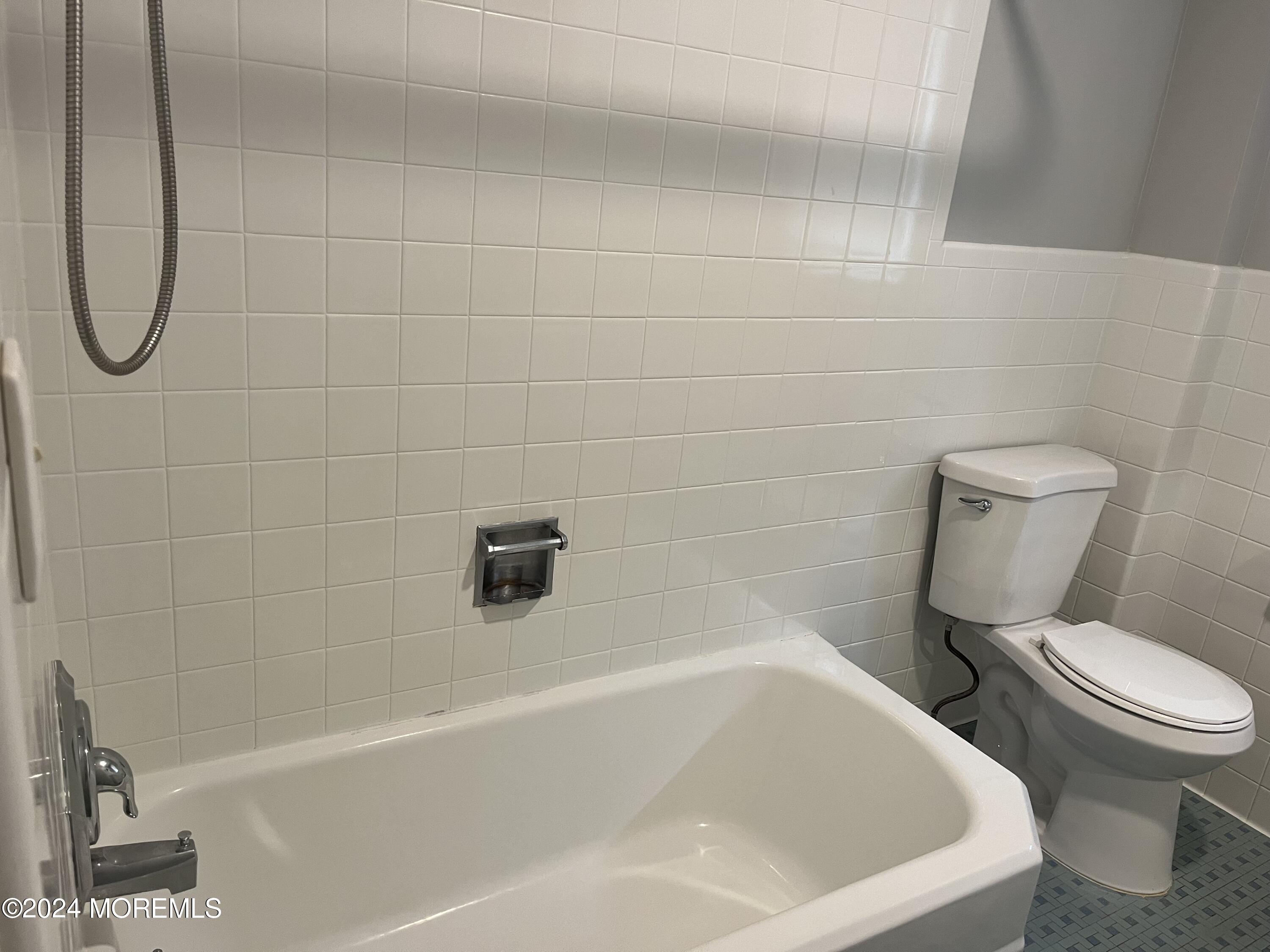 22 Robin Road Rumson, NJ 07760 - Photo 15 of 24 a white bath tub sitting next to a white toilet and a sink