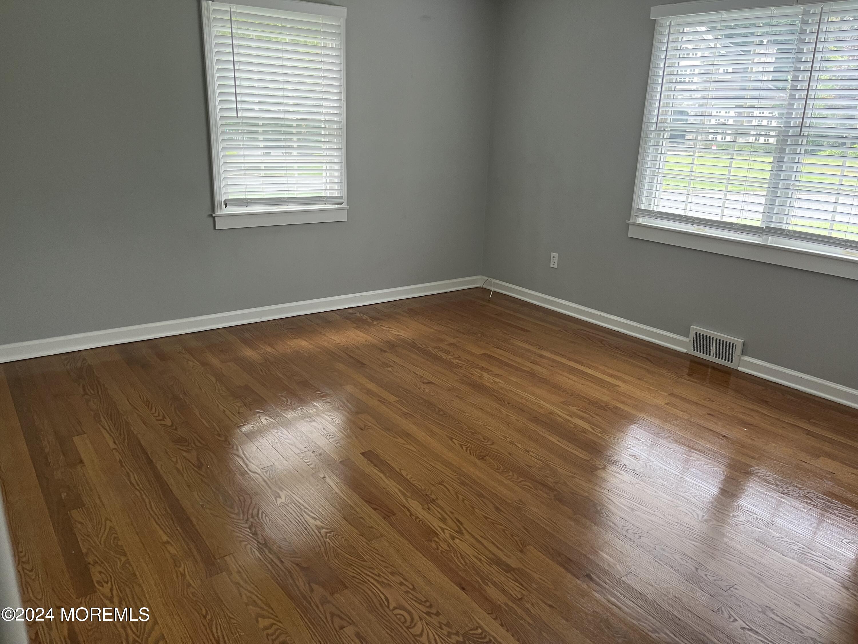 22 Robin Road Rumson, NJ 07760 - Photo 16 of 24 an empty room with wooden floor and windows