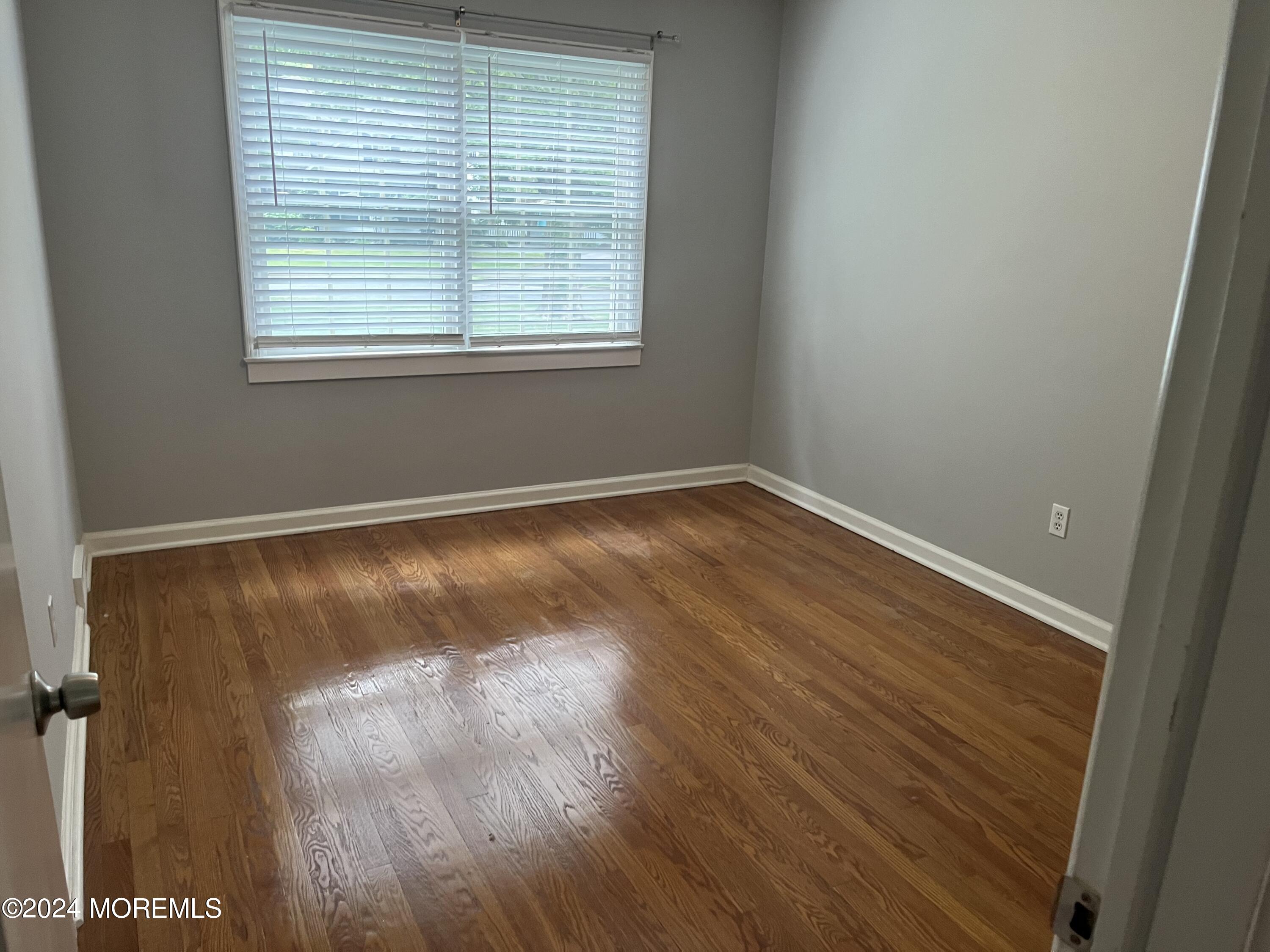 22 Robin Road Rumson, NJ 07760 - Photo 17 of 24 an empty room with wooden floor and windows