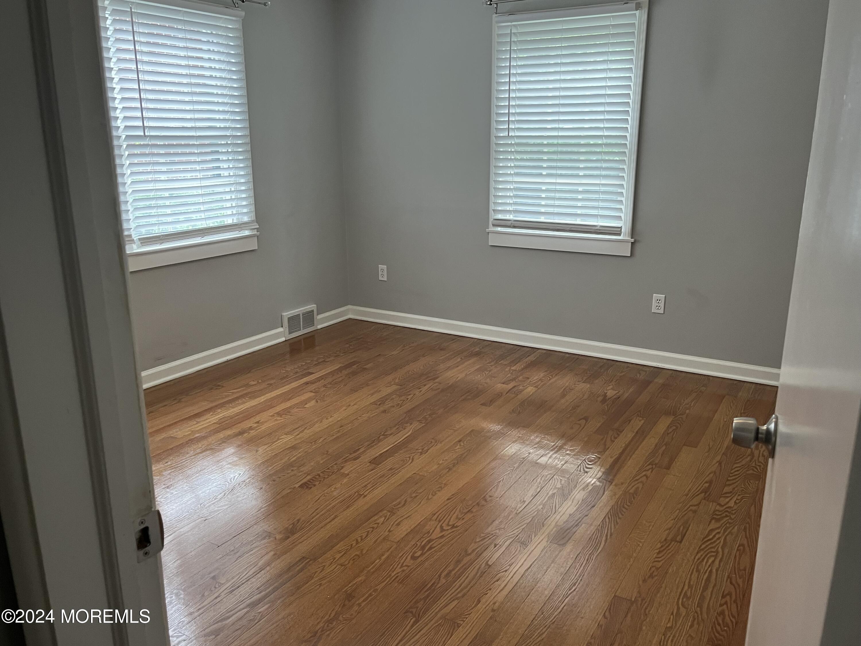 22 Robin Road Rumson, NJ 07760 - Photo 18 of 24 a view of an empty room with wooden floor and a window