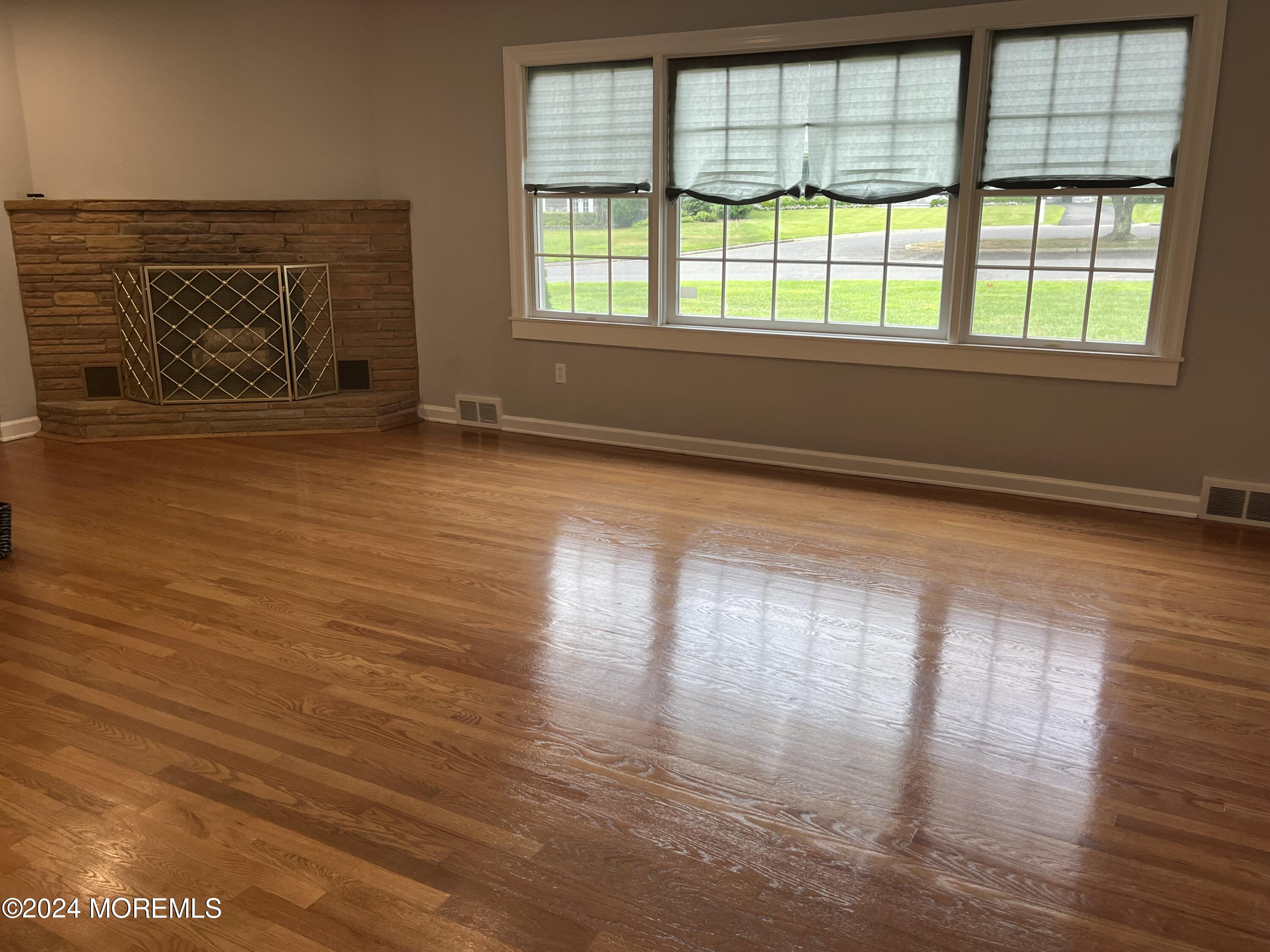 22 Robin Road Rumson, NJ 07760 - Photo 8 of 24 a view of empty room with wooden floor and fan