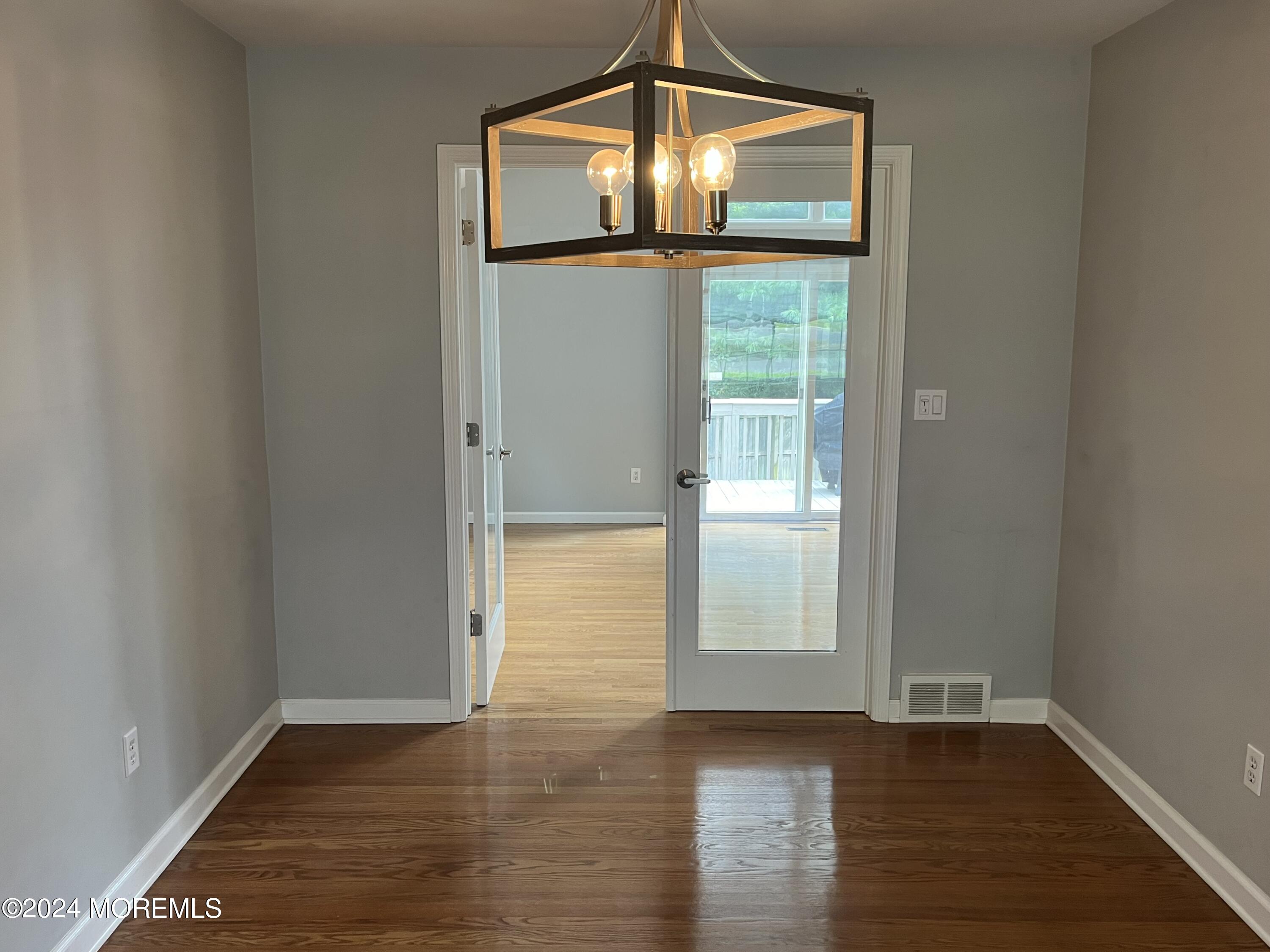 22 Robin Road Rumson, NJ 07760 - Photo 9 of 24 a view of empty room with wooden floor and fan