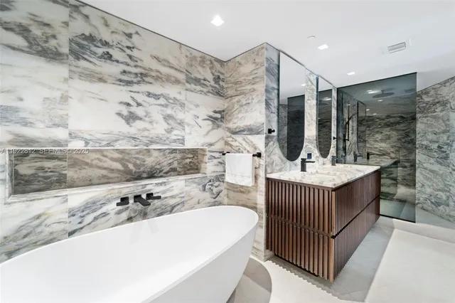 a large white tub sitting in a bathroom