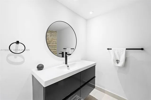 a living room with furniture flat screen tv and a large window