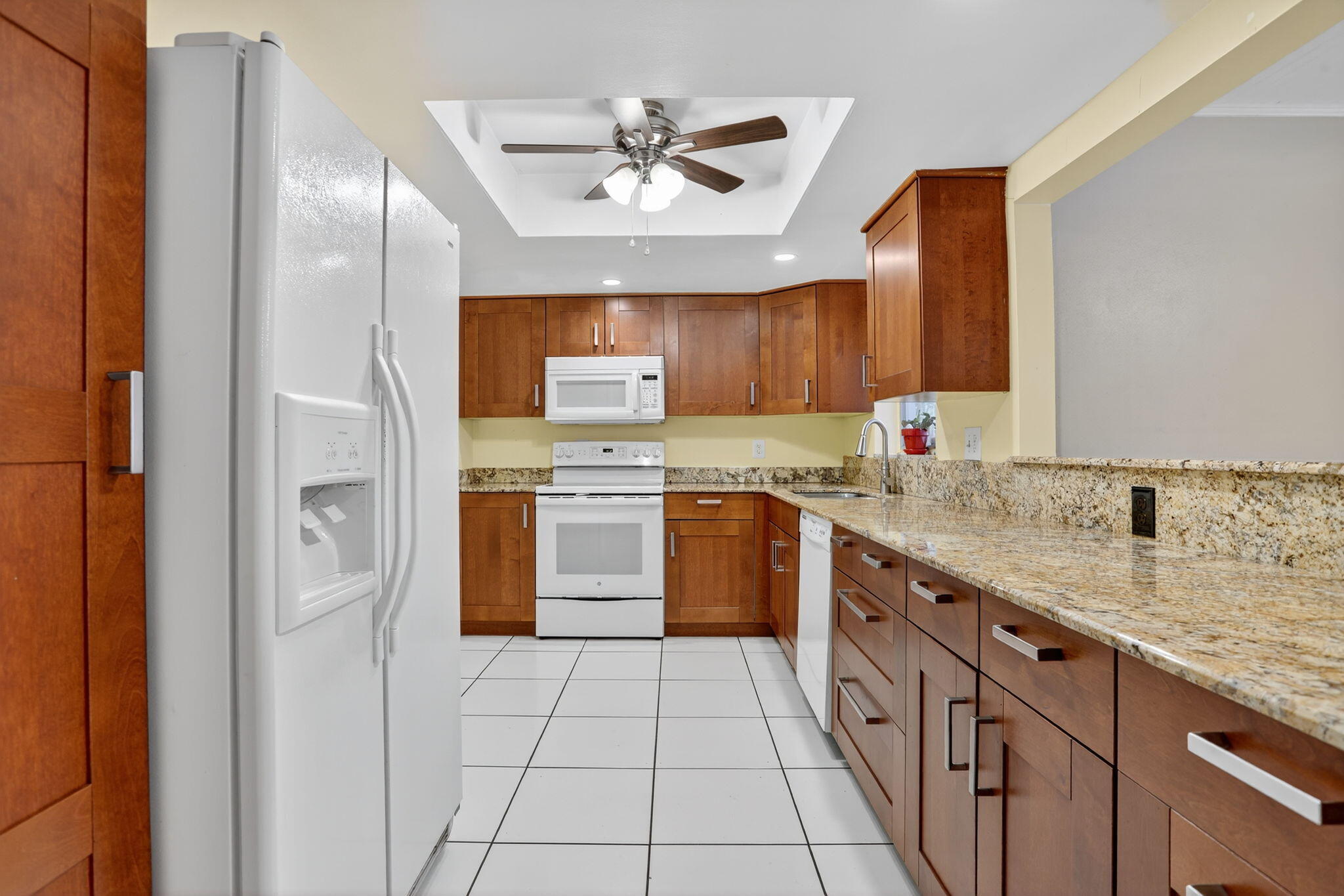 161 Northwest 24th Court Pompano Beach, FL 33064 - Photo 10 of 45 a kitchen with stainless steel appliances granite countertop a sink stove and refrigerator