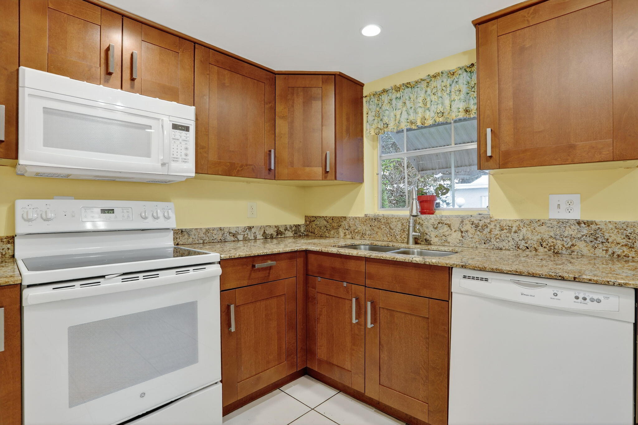 161 Northwest 24th Court Pompano Beach, FL 33064 - Photo 11 of 45 a kitchen with granite countertop cabinets stainless steel appliances and a sink