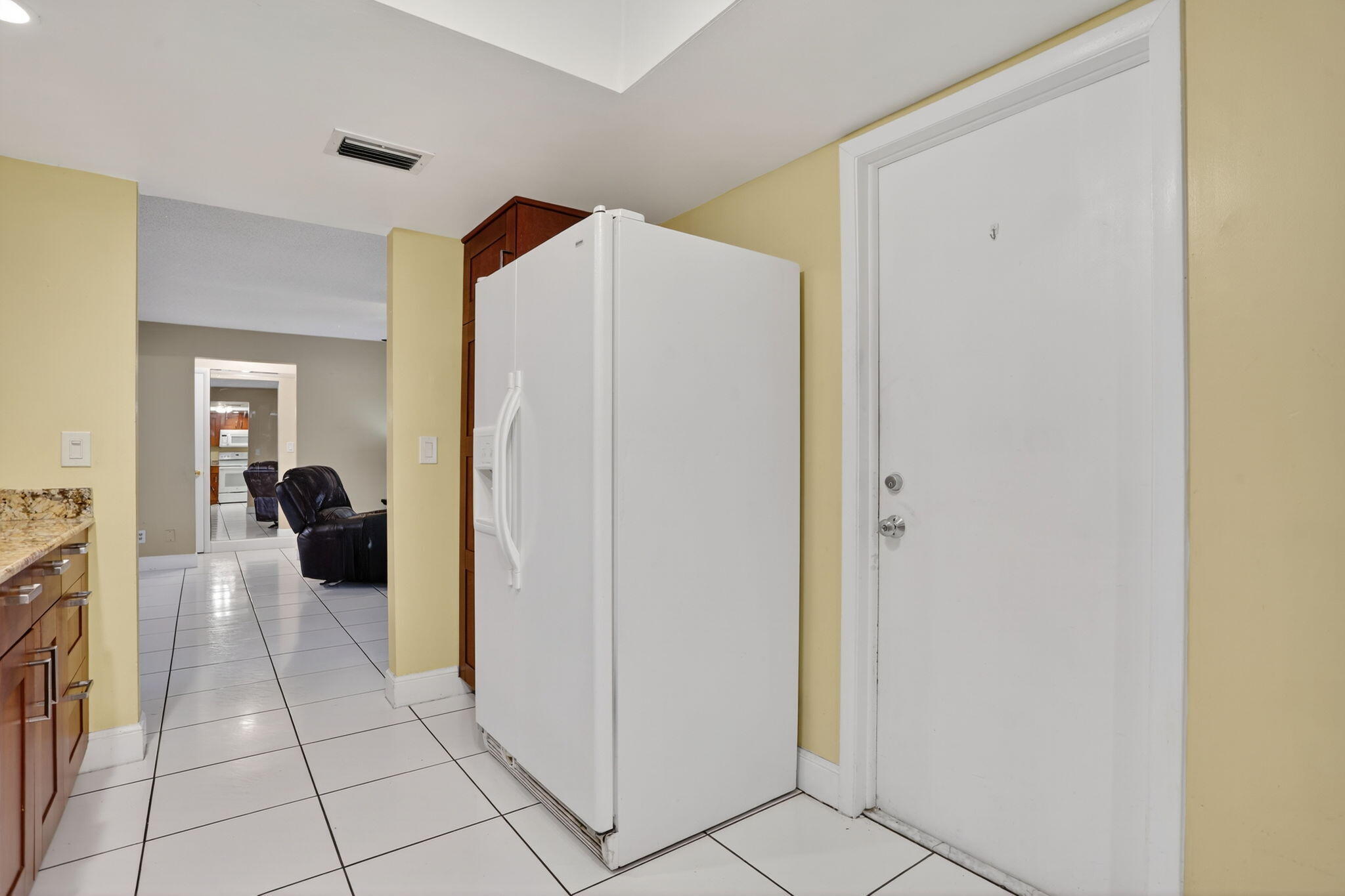 161 Northwest 24th Court Pompano Beach, FL 33064 - Photo 13 of 45 a living room with furniture and a refrigerator