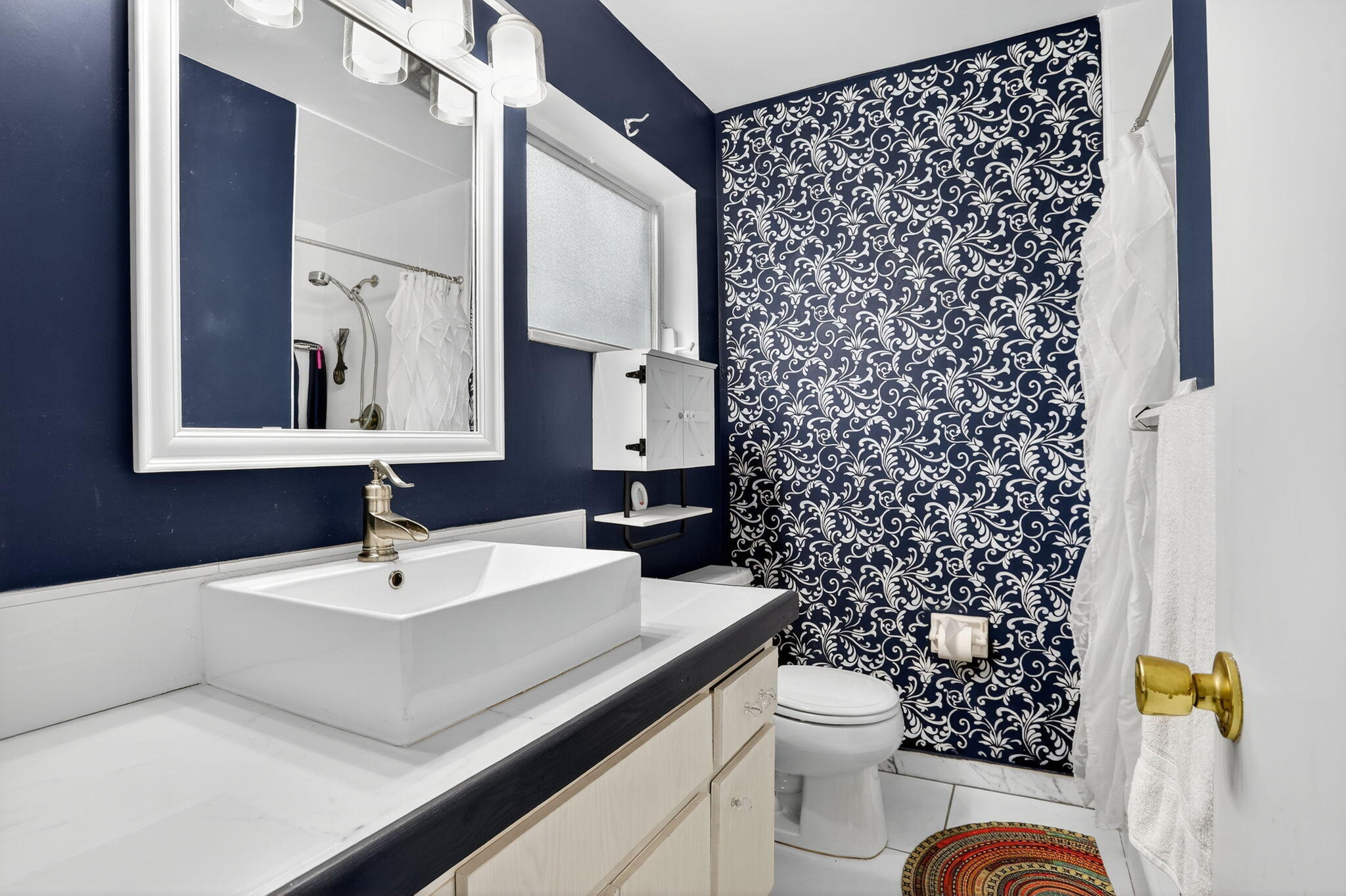 161 Northwest 24th Court Pompano Beach, FL 33064 - Photo 16 of 45 a bathroom with a sink a toilet and a mirror