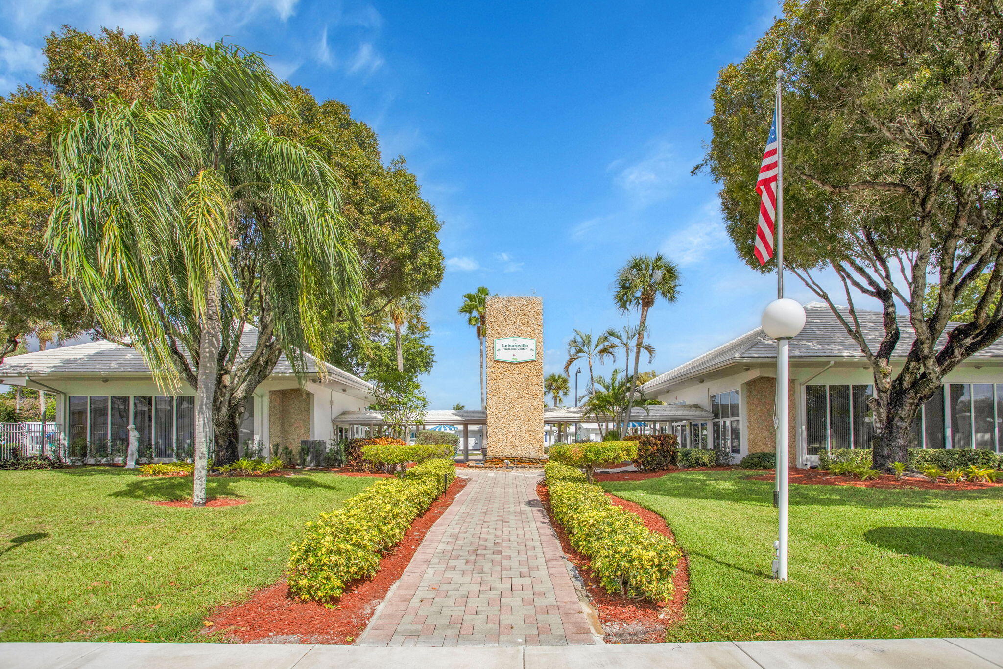 161 Northwest 24th Court Pompano Beach, FL 33064 - Photo 36 of 45 a view of house with garden and tall trees