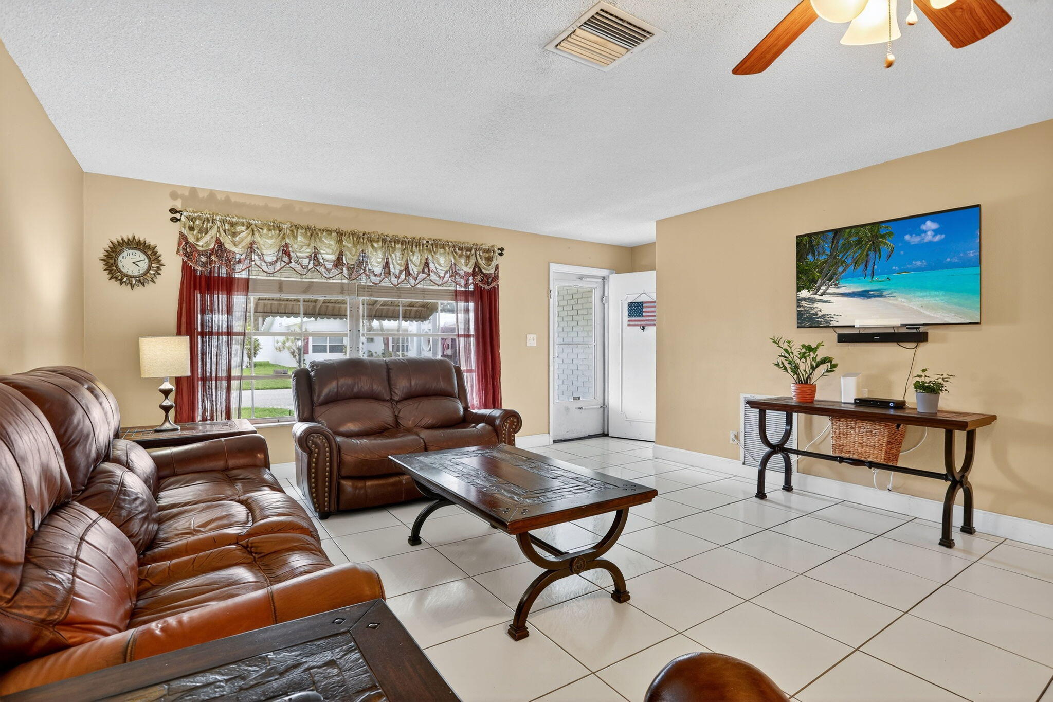 161 Northwest 24th Court Pompano Beach, FL 33064 - Photo 6 of 45 a living room with furniture a rug and a projector