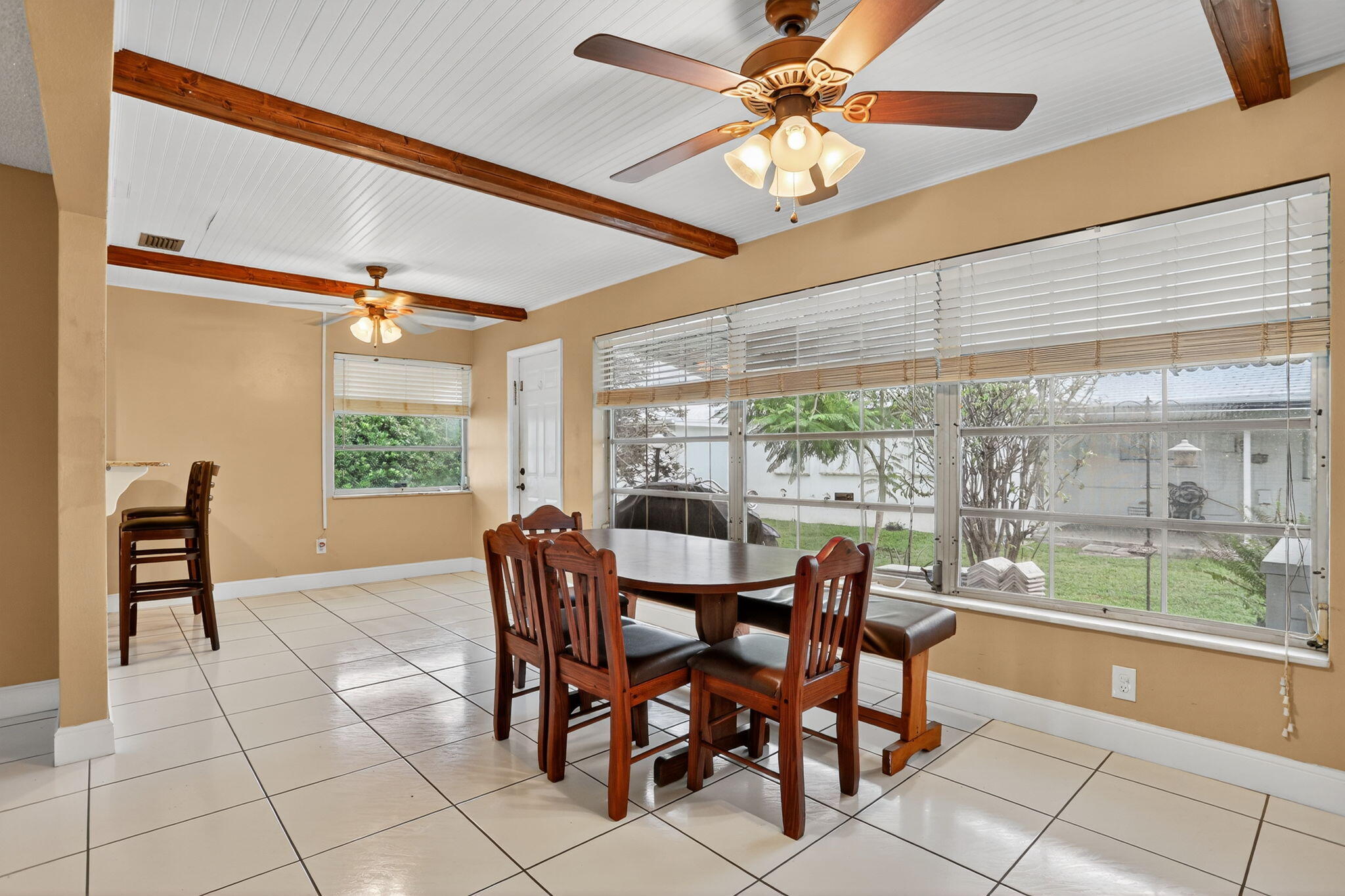 161 Northwest 24th Court Pompano Beach, FL 33064 - Photo 7 of 45 a dining room with furniture a rug and a large window