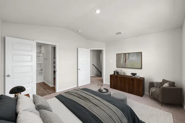 a bedroom with a bed and a couch