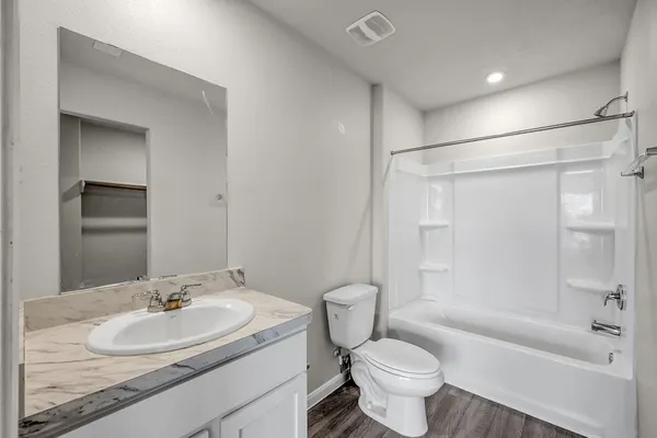 a bathroom with a sink toilet tub and shower