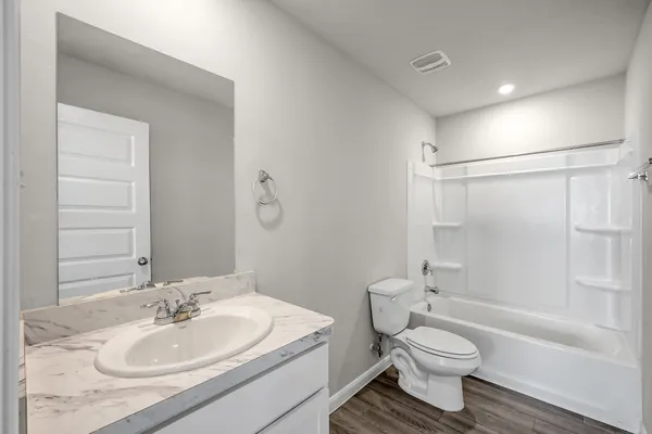a bathroom with a sink toilet tub and shower