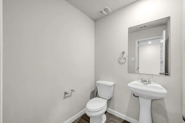 a bathroom with a sink toilet and a mirror