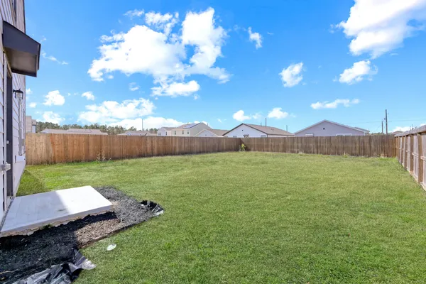 a view of a backyard with table and chairs with wooden fence