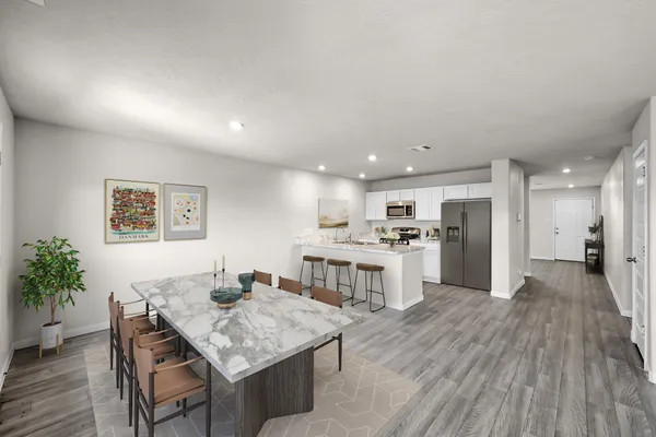 a kitchen with a table and chairs in it
