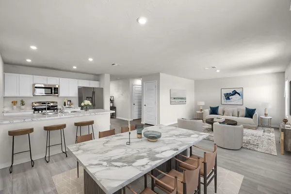 a large kitchen with a table and chairs
