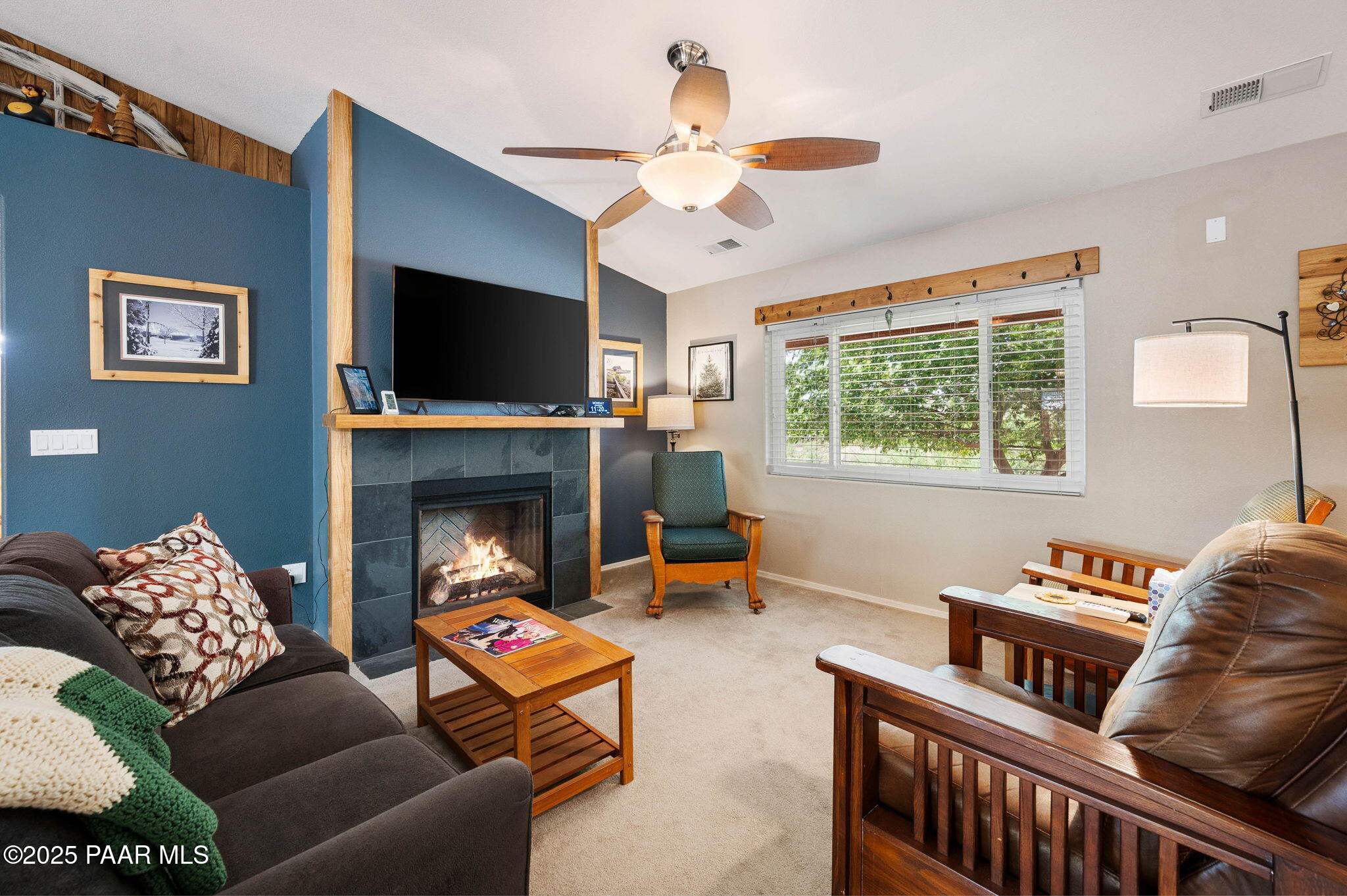 17798 East Trails End Road Mayer, AZ 86333 - Photo 6 of 30 a living room with furniture a flat screen tv and a fireplace