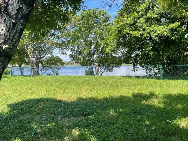 a view of yard with swimming pool and small cabin