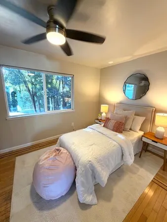 a bedroom with a bed and a painting on the wall