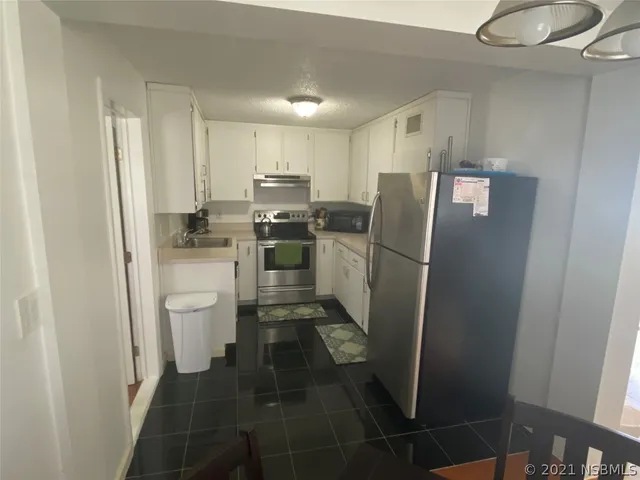a kitchen with a refrigerator a sink and dishwasher