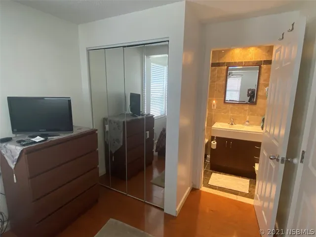 a bathroom with a sink a toilet a mirror and shower