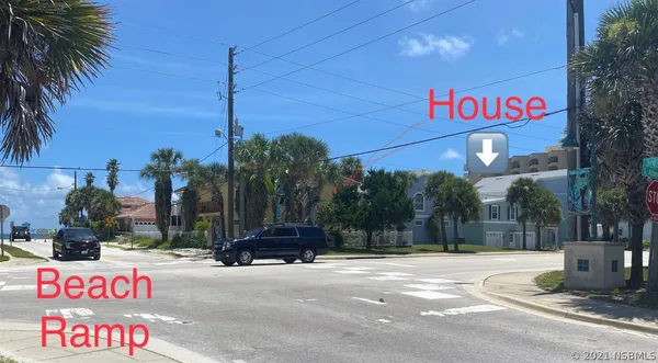 a street sign on a sidewalk next to a road