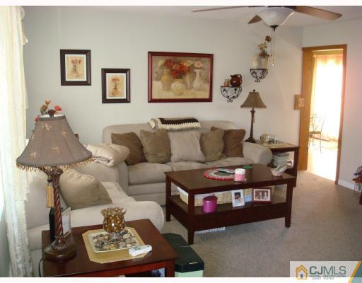 51 Brookville Road Edison, NJ 08817 - Photo 3 of 10 a living room with furniture and a window