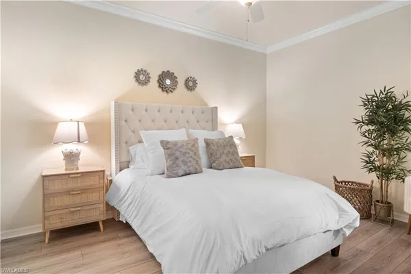 a large bed sitting in a bedroom and a table