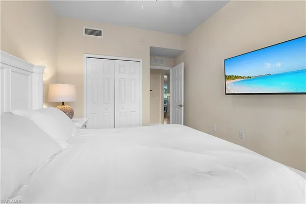 a large white bed in a white room