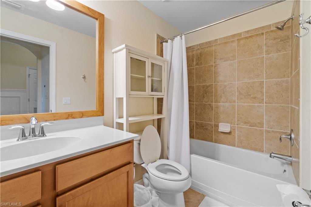 9727 Acqua Court, Unit 436 Naples, FL 34113 - Photo 16 of 40 a bathroom with a sink toilet and shower