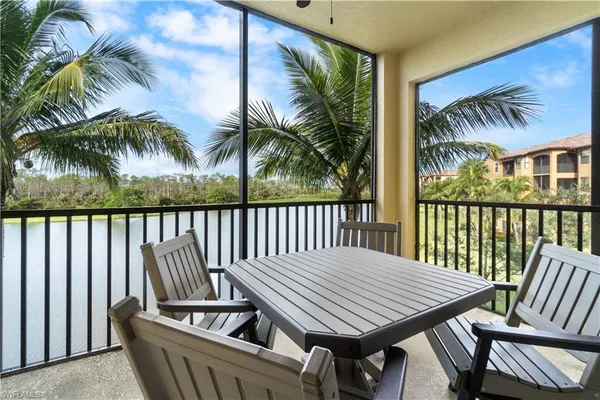 a view of a patio with a table and chairs